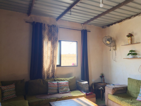 Muna lives in harsh conditions in a zinc-roofed house that lacks water, electricity, and protection from the weather